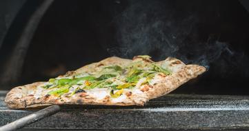 Beautiful, baked Italian pizza with smoke, in the oven