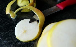 Peeling colorful and beautiful pears, with knife