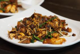 Colorful and beautiful, Malaysian food on the shiny, white plates