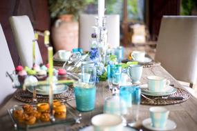 Beautiful and colorful, served table, among the chairs, in light