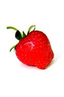 Close-up of the beautiful, red strawberry with green leaves, in light, on white surface