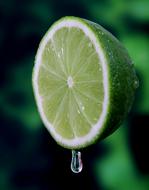 Lime and juice on a green background