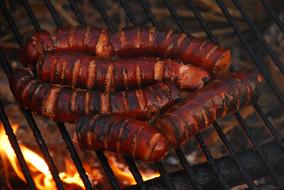 Close-up of the beautiful, cooked sausages, on the grill with fire
