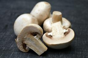 Beautiful, raw, whole and cut mushrooms in light