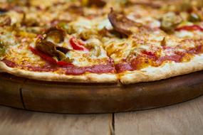 delicious pizza on a wooden board close-up