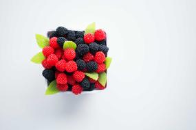 gummi candy in the form of raspberries and blueberries in a plate