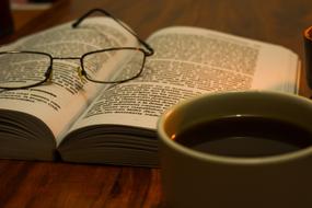 glasses on a book and a cup of tea
