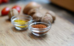 spices in glass bowls in the kitchen on a blurred background