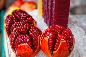Beautiful, open pomegranates on the ice, in Thailand
