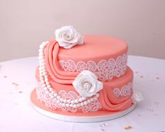 pink birthday cake with white roses for decoration