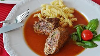 beef rolls with tomato sauce in a plate