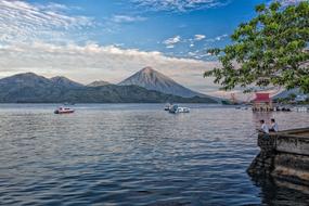Fishermen on the beautiful coast in Halmahera, Indonesia, with plants and mountains