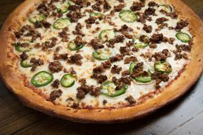 Beautiful and colorful pizza with cheese, meat and jalapeno