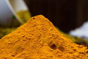 yellow seasoning for food on blurred background