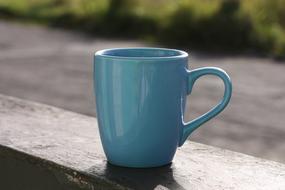 a cup of coffee outside on a blurred background