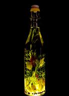 sunflower oil with garlic and herbs on a black background