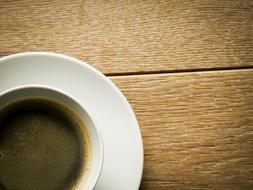 porcelain cup with coffee drink on the table