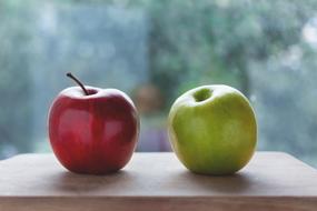 red and green apples on a cutting board