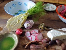 preparing salad, radishes, vegetables and homemade cheese