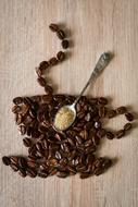 cup of coffee beans on a wooden surface