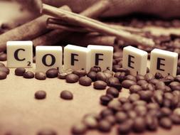Cubes with "Coffee" sign, among the beautiful coffee beans