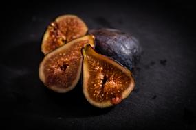 Close-up of the beautiful and colorful, whole and cut figs, in light