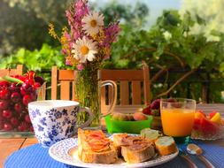 Breakfast served on table in garden at summer