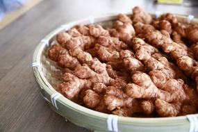 lots of ginger in a wicker bowl
