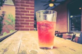 pink drink with ice in a glass