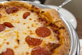 Beautiful, cooked pepperoni pizza on the shiny, metallic plate