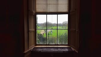 view of green trees and park through the window, ireland, malahide castle