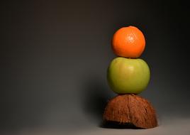 tower of orange and apple on coconut