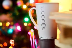 a cup of coffee on a table on a blurred background