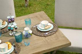 Close-up of the wooden table with colorful cutlery