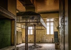 Interior of the old, abandoned kitchen in the hotel, with windows with light