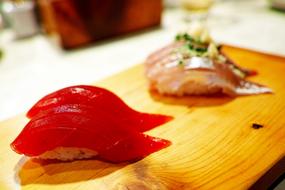 Close-up of the colorful sushi on the wooden board, in light