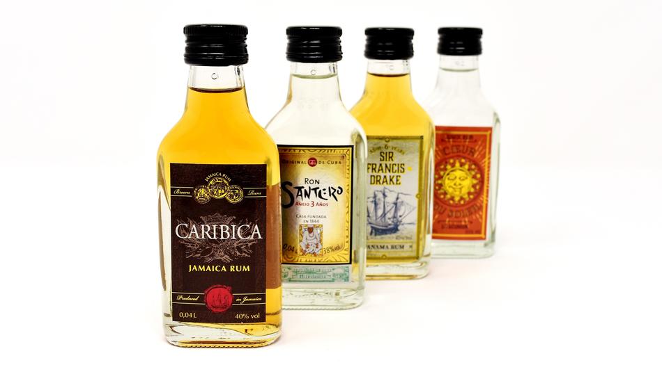 Beautiful and colorful bottles with the alcohol, on the white surface