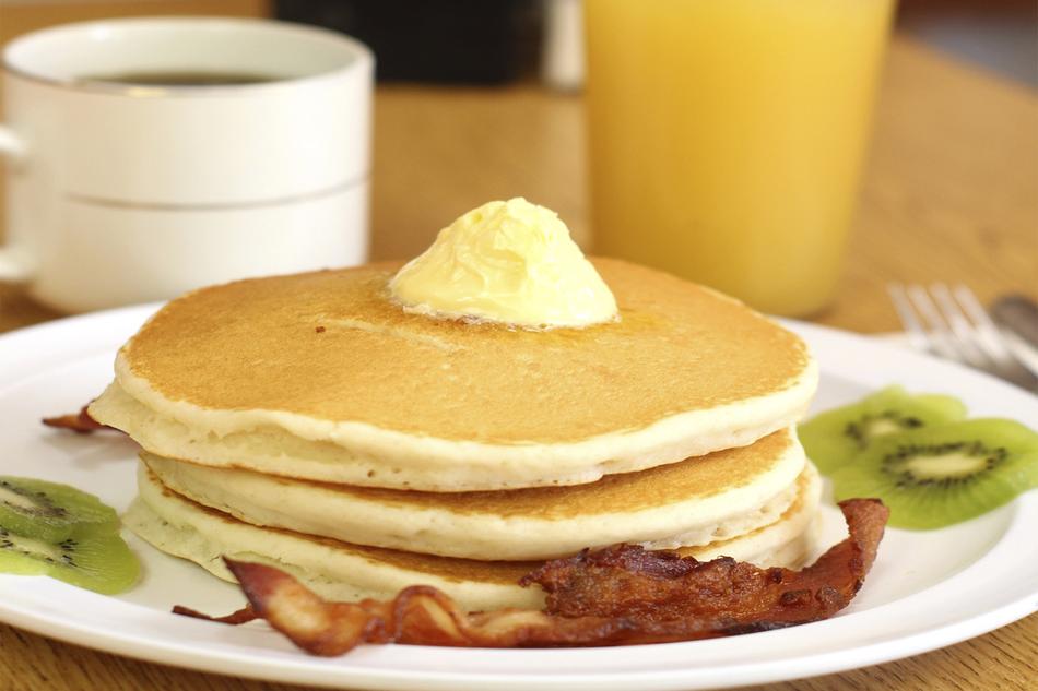 Beautiful hotcakes with fruits, cream, orange juice and coffee
