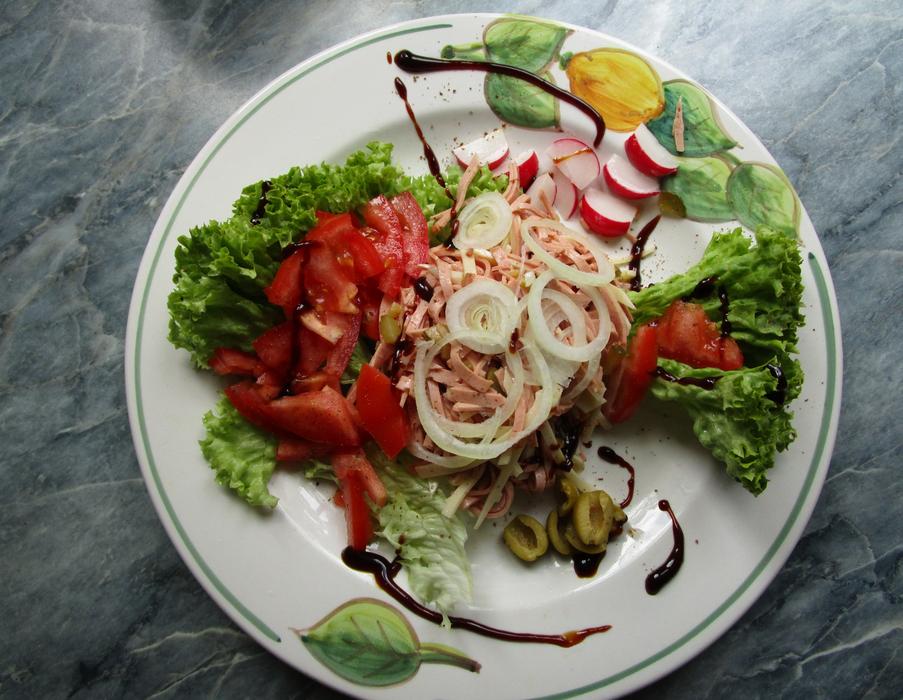 vitamin salad with onions on a white plate
