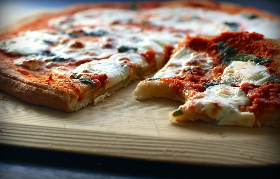 Beautiful and colorful Margarita pizza with cheese, on the wooden board