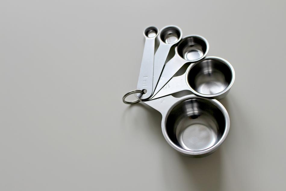 Close-up of the metal measuring cup, on the table