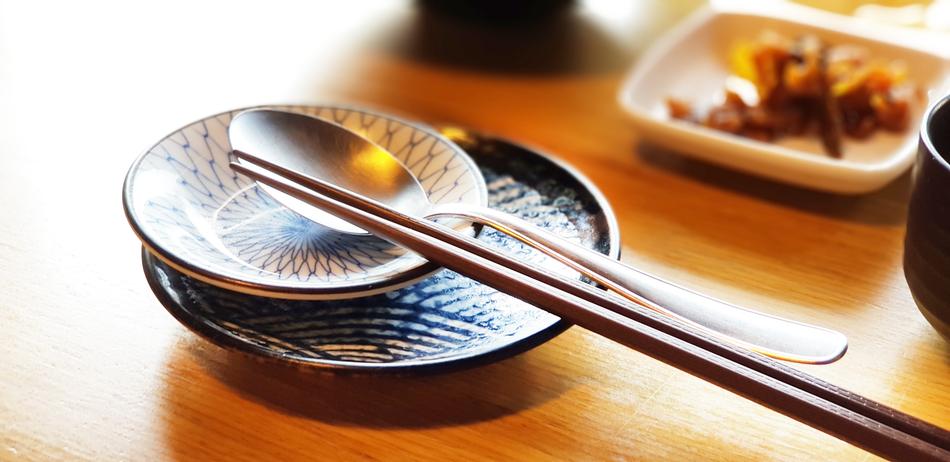 Chopsticks and spoons close-up on blurred background