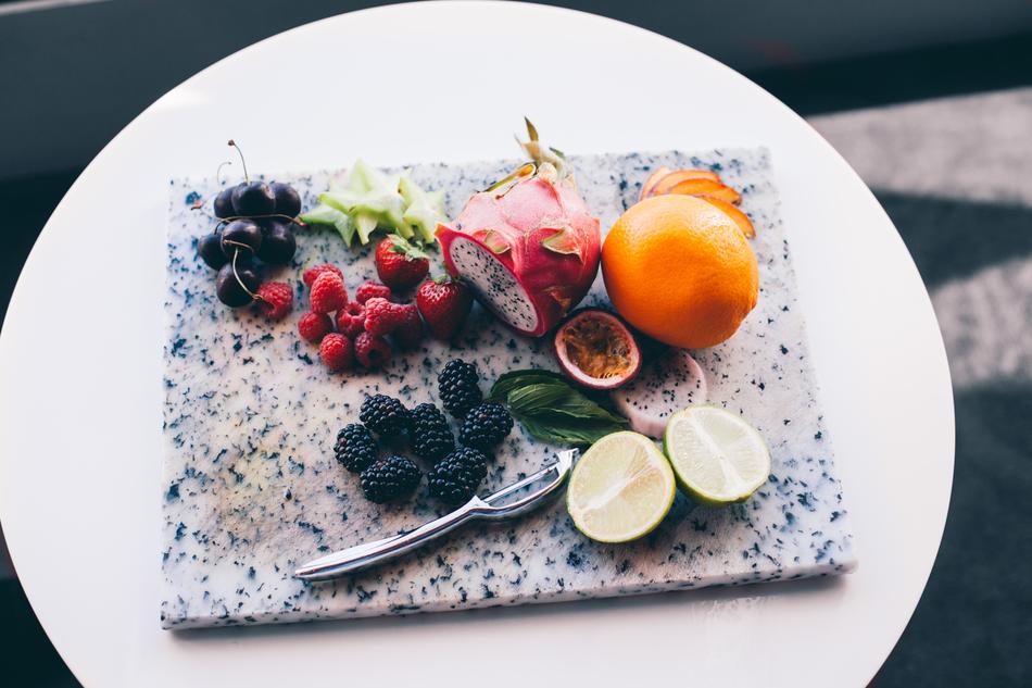 Beautiful and colorful fruits and berries on the plate, in light