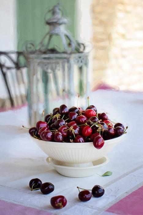 Cherries In Bowl on the table in a blurred background