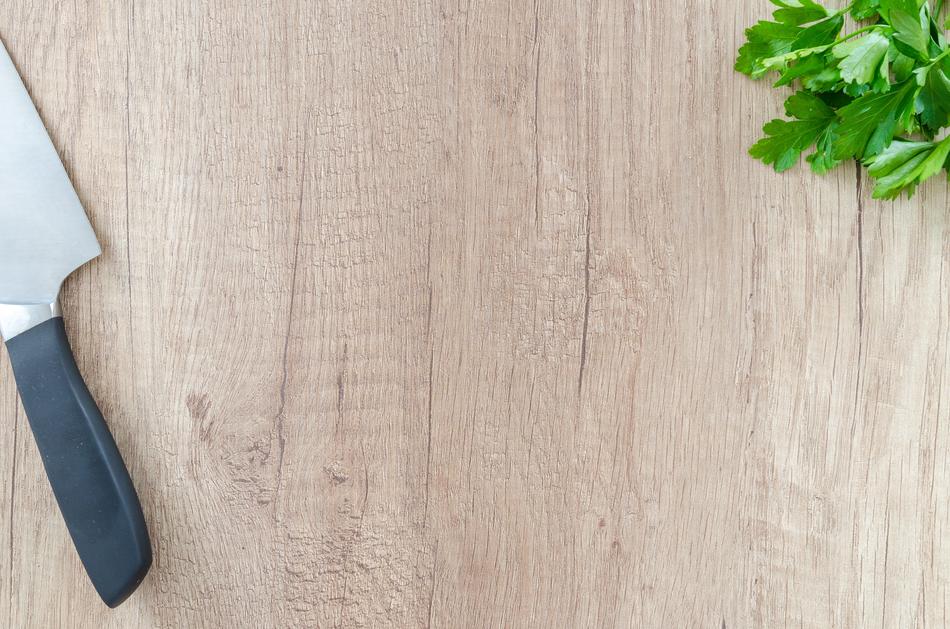 Knife on a wooden cutting board close up