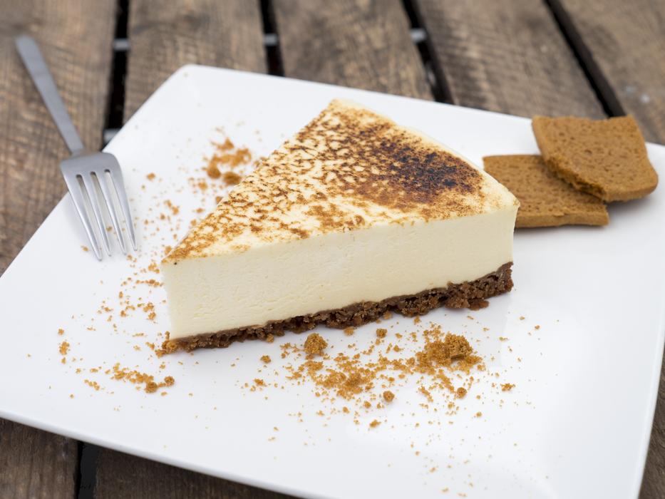 Beautiful and colorful pie with cookies, on white plate with fork