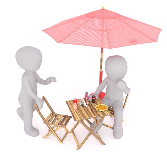 White figures eating fast food at the table with parasol, at white background