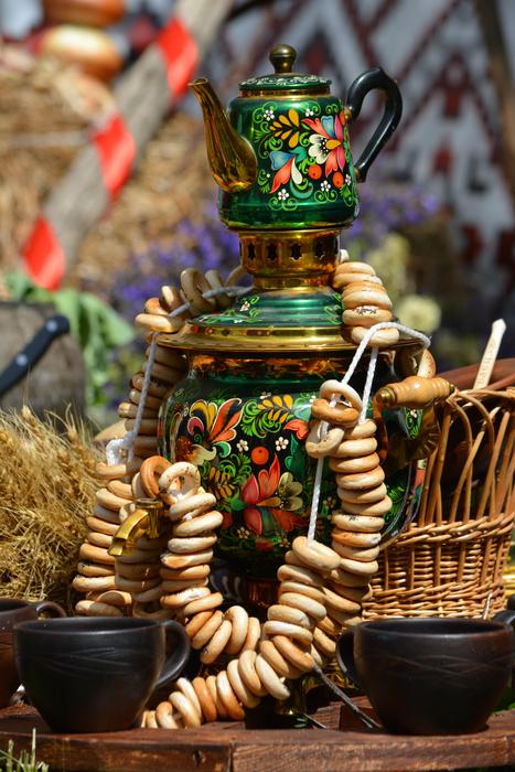 Russian tableful with colorful and beautiful, patterned samovar and food