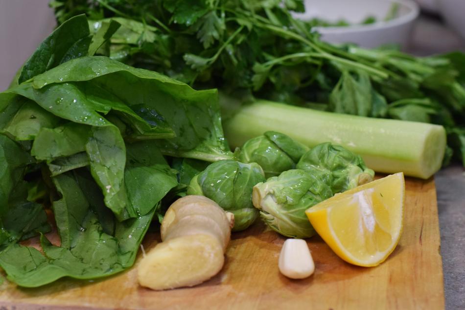 Beautiful, greenery in water drops, lemon and garlic on the wooden board