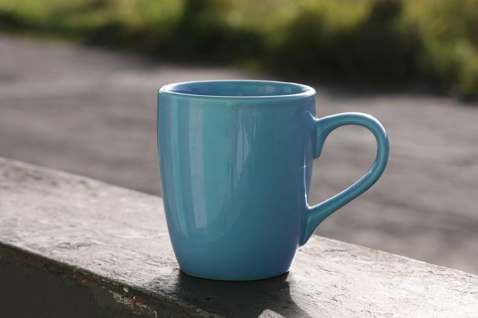 a cup of coffee outside on a blurred background